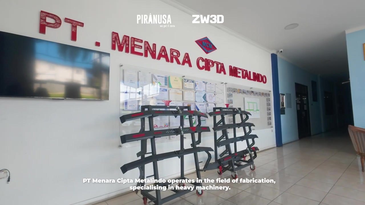 Interior kantor PT Menara Cipta Metalindo dengan tulisan nama perusahaan dan display produk rak logam.