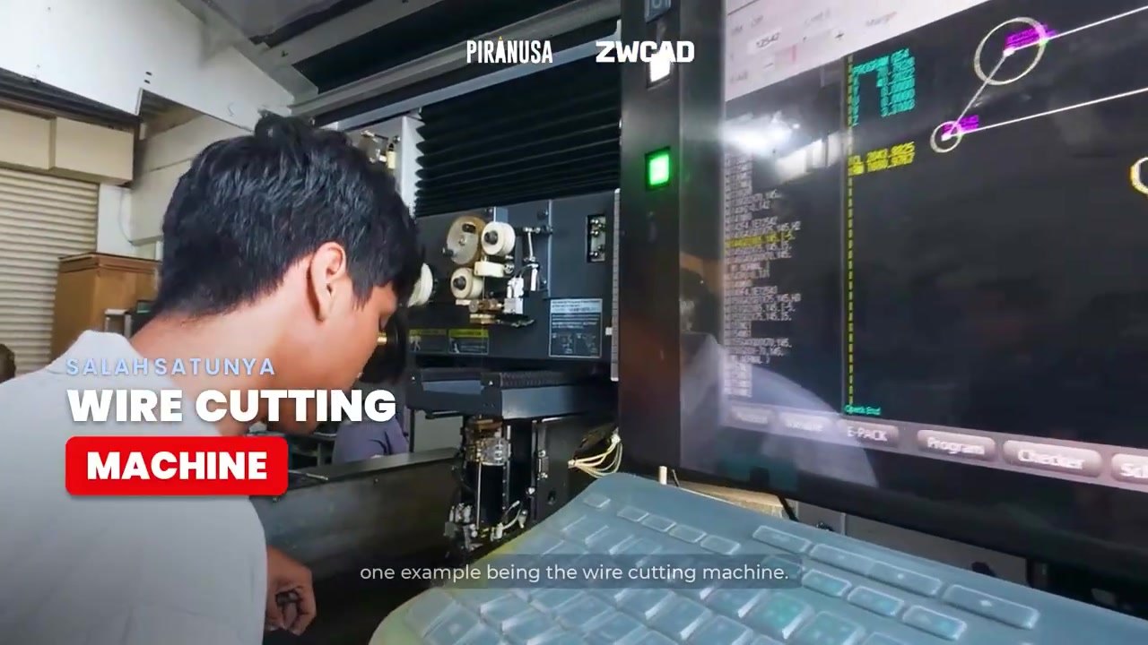 Operator mengawasi mesin wire cutting dengan layar kontrol data teknis